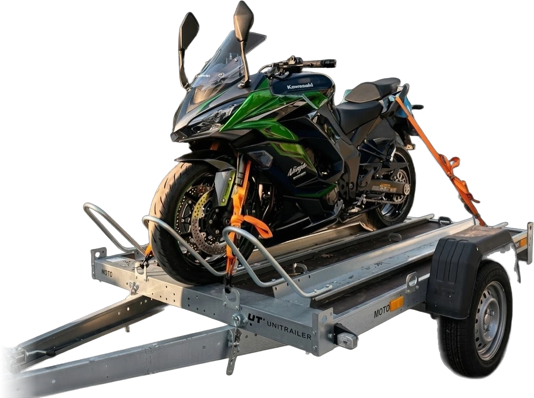 Przyczepka motocyklowa MotoPaka z kołyską najazdową i motocyklem Kawasaki Ninja spiętym pomarańczowymi pasami z napinaczami